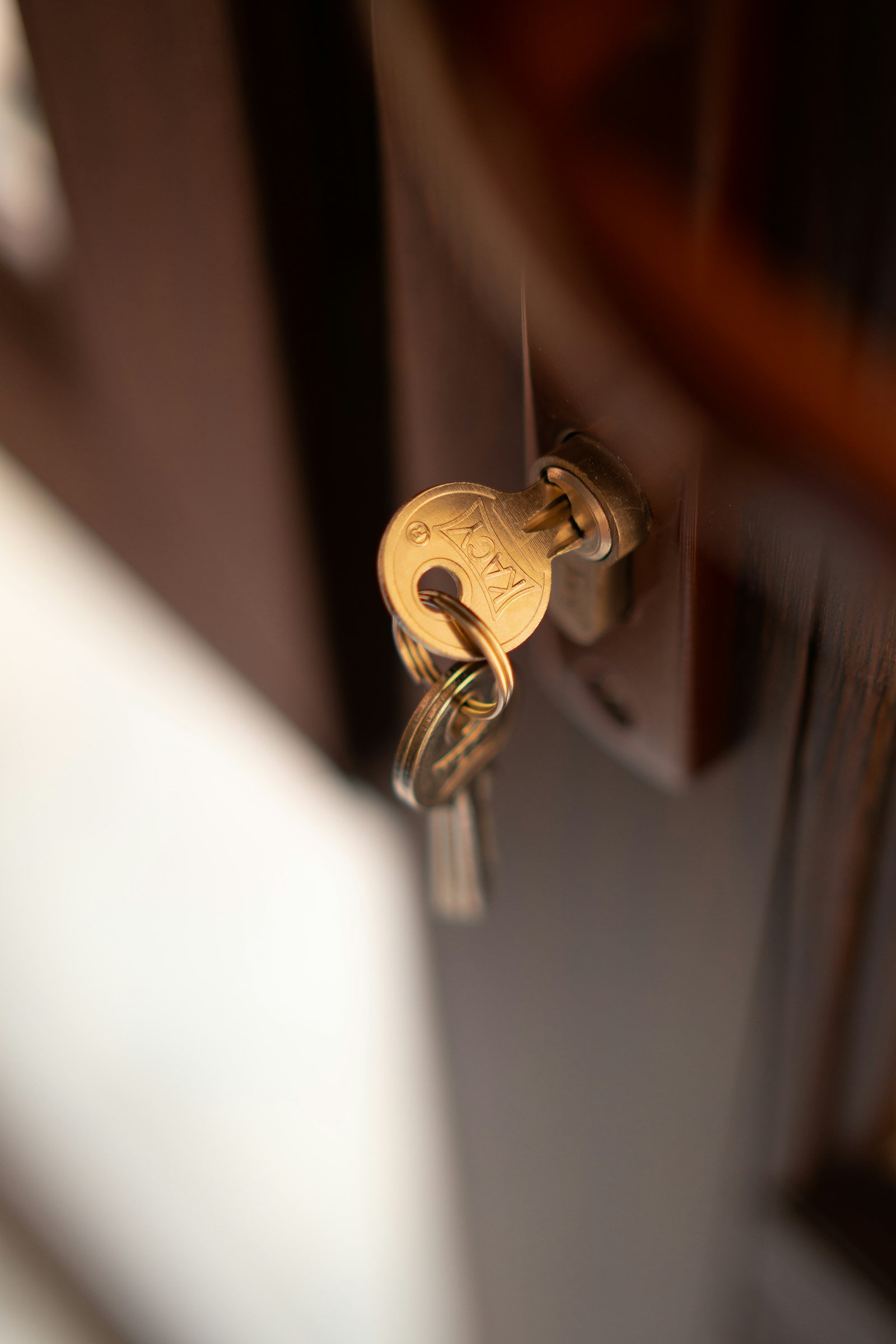 Brass key inserted in a door lock cylinder